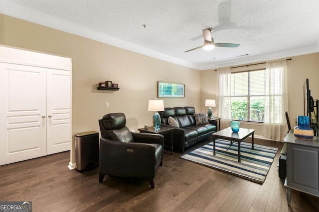 living room with ornamental molding, ceiling fan, a textured ceiling, and wood finished floors