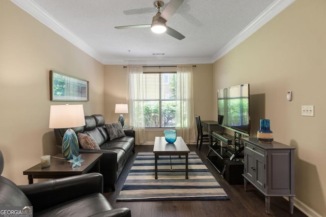 living room featuring visible vents, dark wood-type flooring, ornamental molding, a textured ceiling, and baseboards