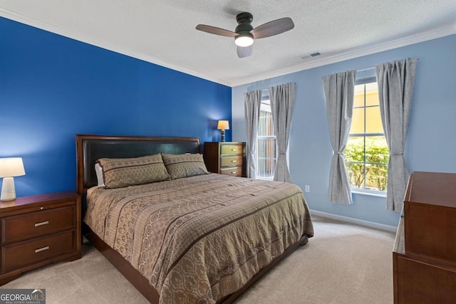 bedroom featuring visible vents, ornamental molding, a textured ceiling, and light colored carpet