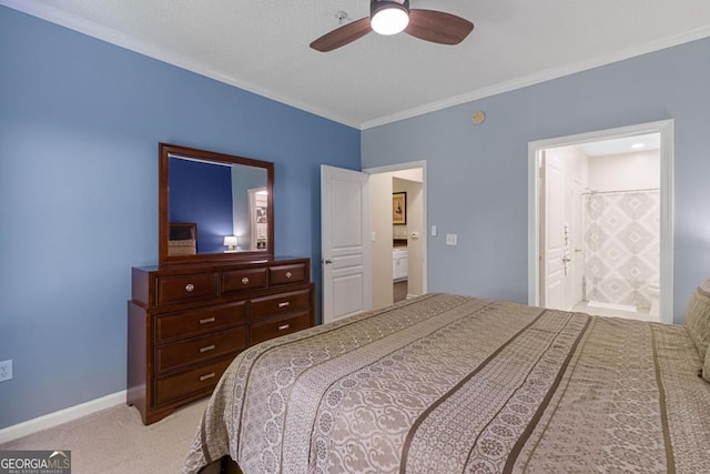 bedroom featuring carpet, crown molding, a ceiling fan, ensuite bath, and baseboards