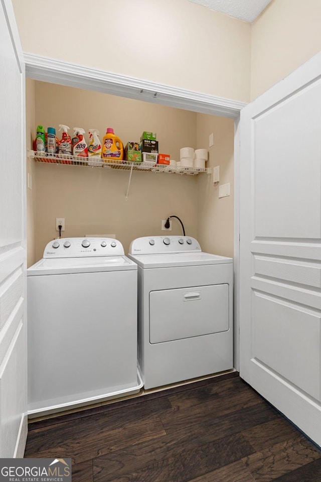 laundry room with dark wood-style floors, laundry area, and washing machine and clothes dryer