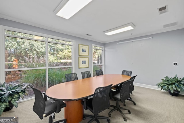 office space with carpet floors, visible vents, ornamental molding, and baseboards