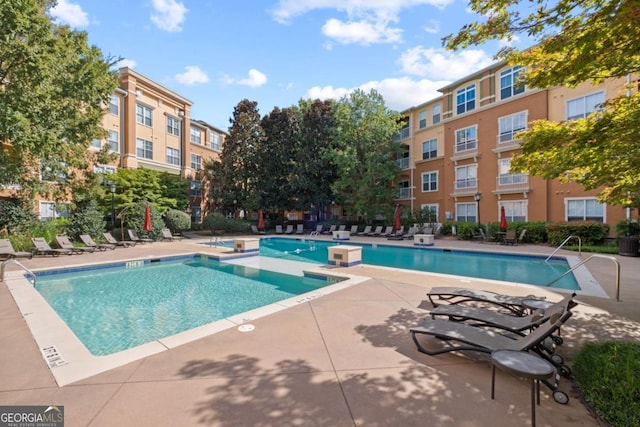 pool featuring a jacuzzi and a patio