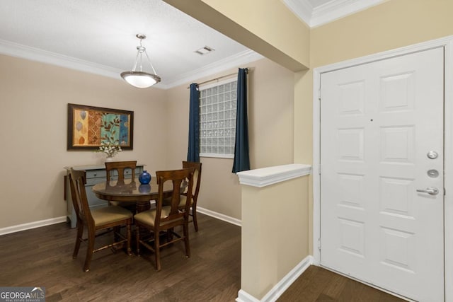 dining area with ornamental molding, dark wood-style flooring, visible vents, and baseboards