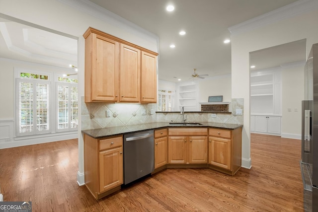 kitchen with crown molding, light wood-type flooring, dishwasher, and a sink