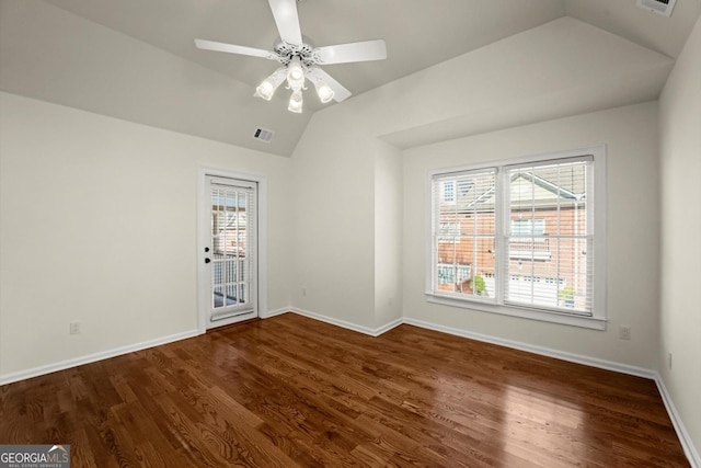 spare room featuring ceiling fan, dark wood-type flooring, visible vents, baseboards, and vaulted ceiling