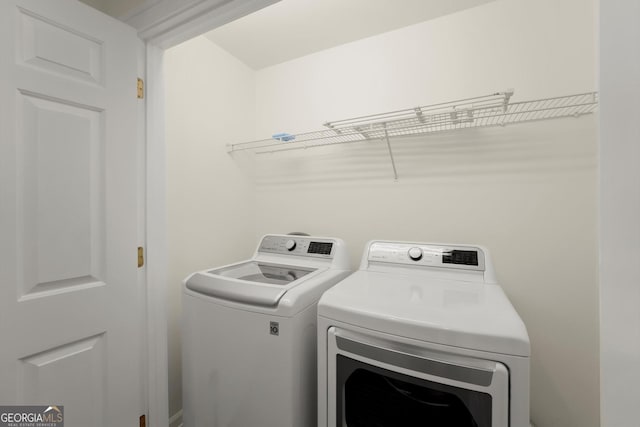 clothes washing area with laundry area and separate washer and dryer