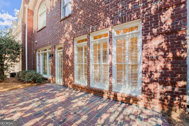 exterior space featuring brick siding