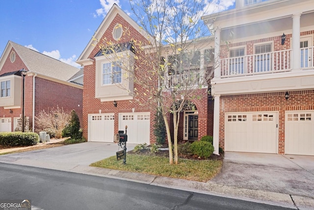 view of front of house with an attached garage, concrete driveway, and brick siding