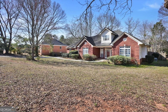 view of front of property with a front yard and brick siding