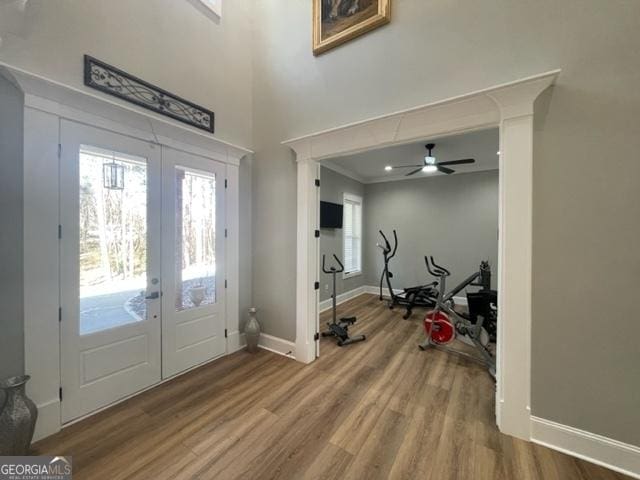 foyer featuring french doors, wood finished floors, and baseboards