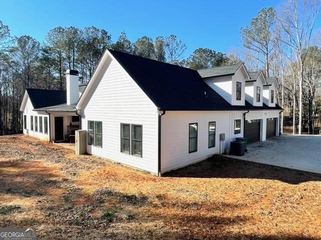 view of home's exterior featuring a garage and driveway