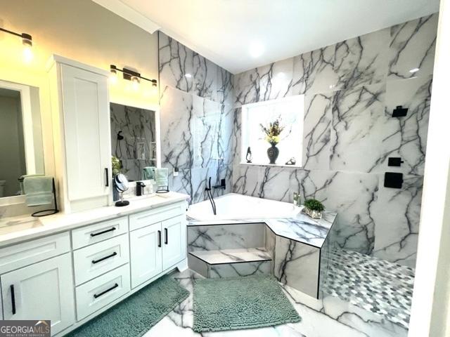 bathroom featuring a garden tub, a sink, and double vanity