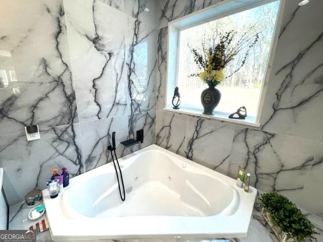 full bathroom with stone wall and a bathing tub