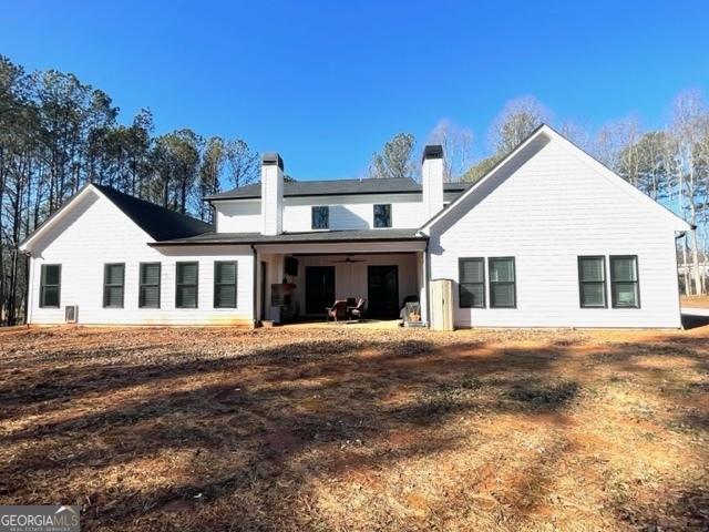 back of property with a chimney