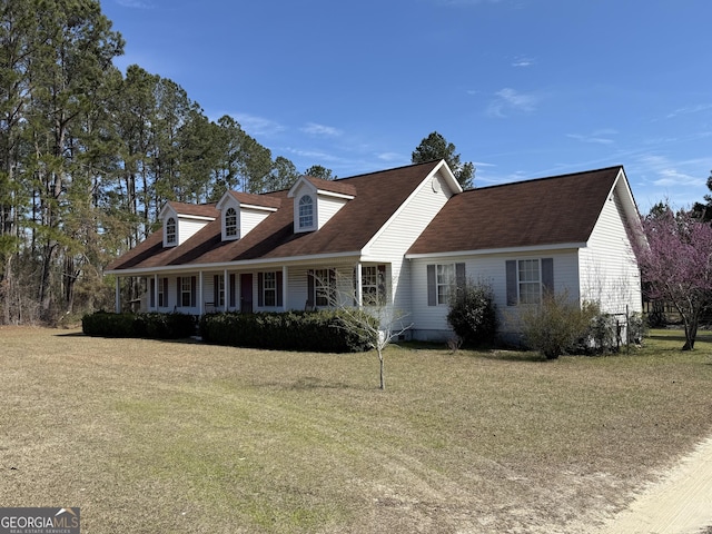 new england style home with a front lawn