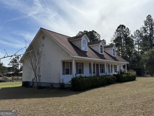 view of side of property with cooling unit and a lawn