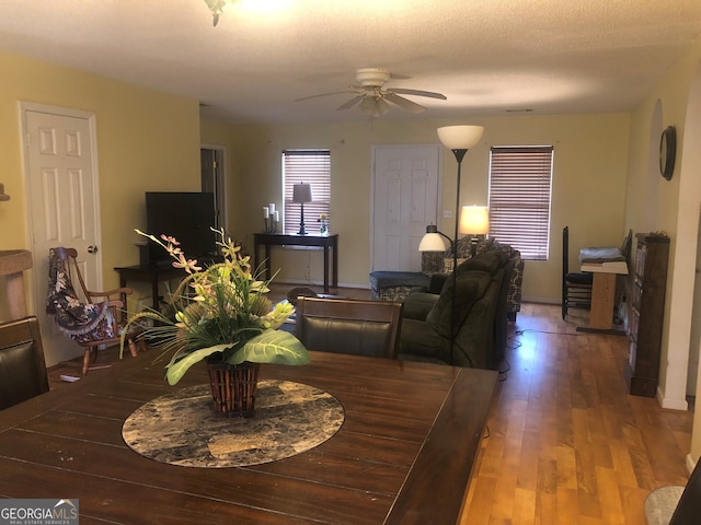 dining room with ceiling fan and wood finished floors