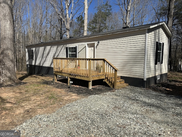 manufactured / mobile home with driveway and a deck