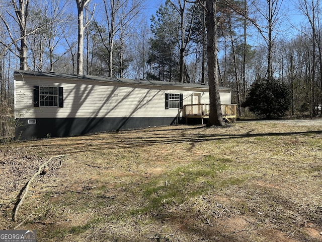 view of property exterior with a deck