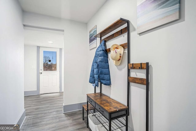 hallway with wood finished floors and baseboards