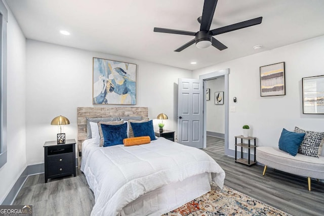 bedroom with recessed lighting, wood finished floors, a ceiling fan, and baseboards