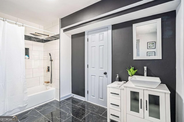 bathroom featuring marble finish floor, shower / tub combo, vanity, and baseboards