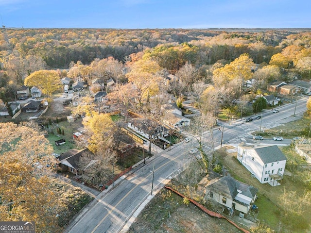 birds eye view of property featuring a wooded view