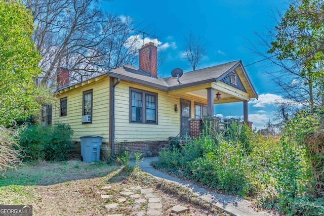 view of side of home with a chimney