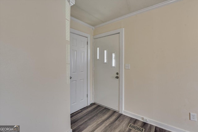 interior space with baseboards, visible vents, ornamental molding, and dark wood-type flooring