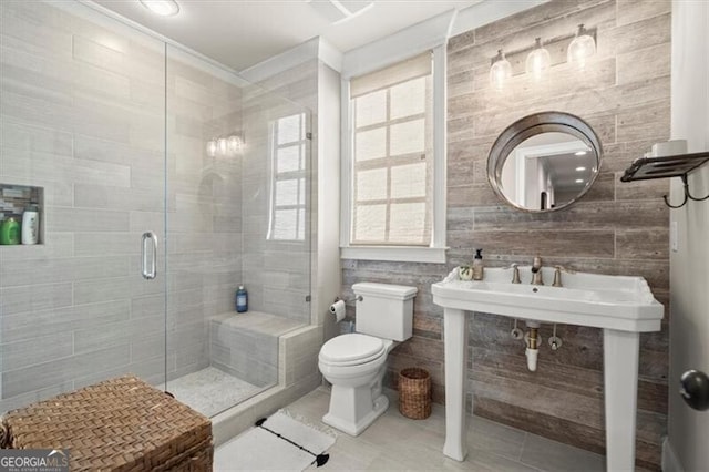 full bathroom with tile patterned flooring, a shower stall, and toilet