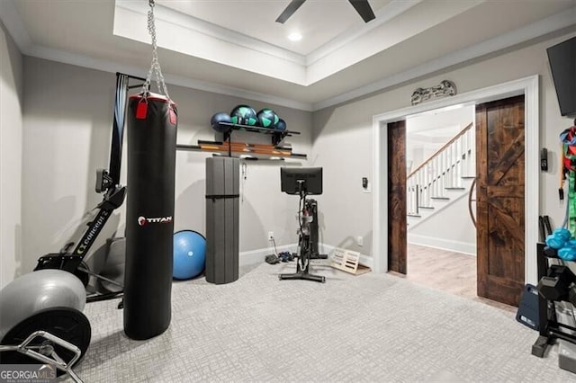 exercise room featuring recessed lighting, a ceiling fan, baseboards, ornamental molding, and a raised ceiling