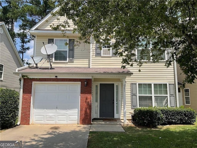 view of front of house with a garage, driveway, and brick siding