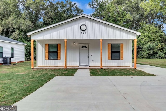 view of front of home with a front lawn, a porch, and central air condition unit