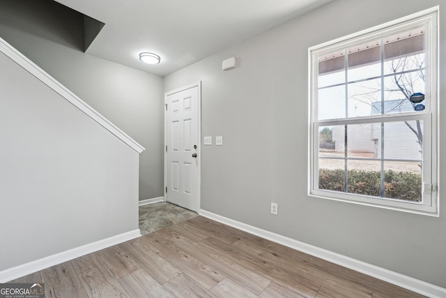 entryway featuring light wood-style floors and baseboards