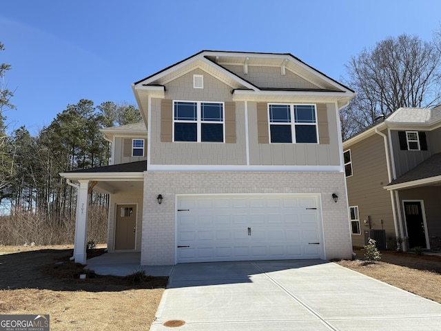 view of front of property with cooling unit, concrete driveway, brick siding, and an attached garage