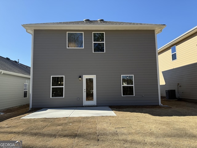 rear view of property with central AC unit and a patio area