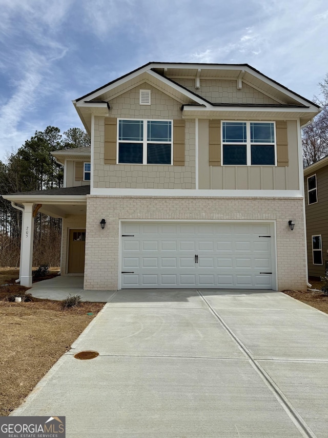 view of front of home with a garage, concrete driveway, and brick siding