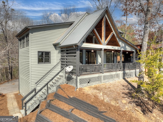 view of front of house with metal roof and a porch