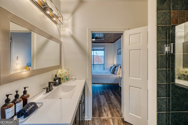 full bath with a tile shower, vanity, ensuite bath, wood finished floors, and wooden ceiling