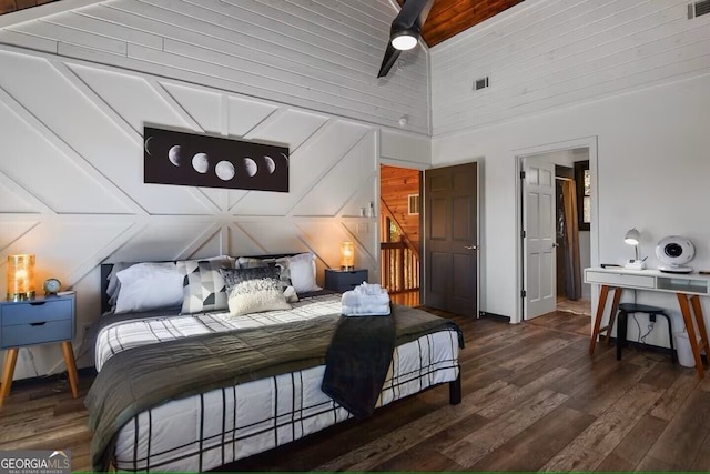 bedroom featuring lofted ceiling, visible vents, and wood finished floors