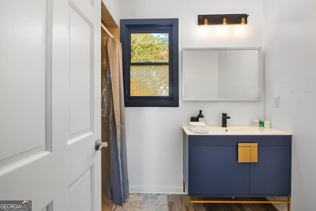 full bathroom with baseboards and vanity