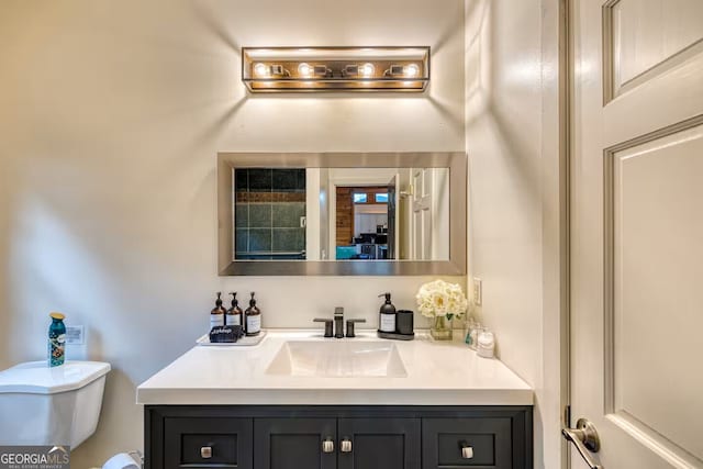 half bathroom featuring toilet and vanity