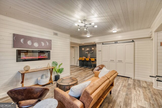 living room featuring wooden ceiling, visible vents, wood finished floors, and an inviting chandelier