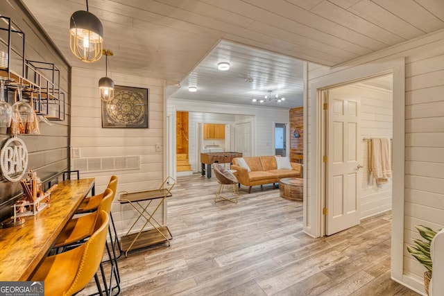 interior space with wooden ceiling, wood walls, and wood finished floors