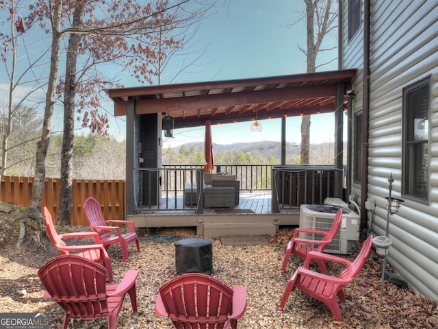 wooden terrace with fence and cooling unit