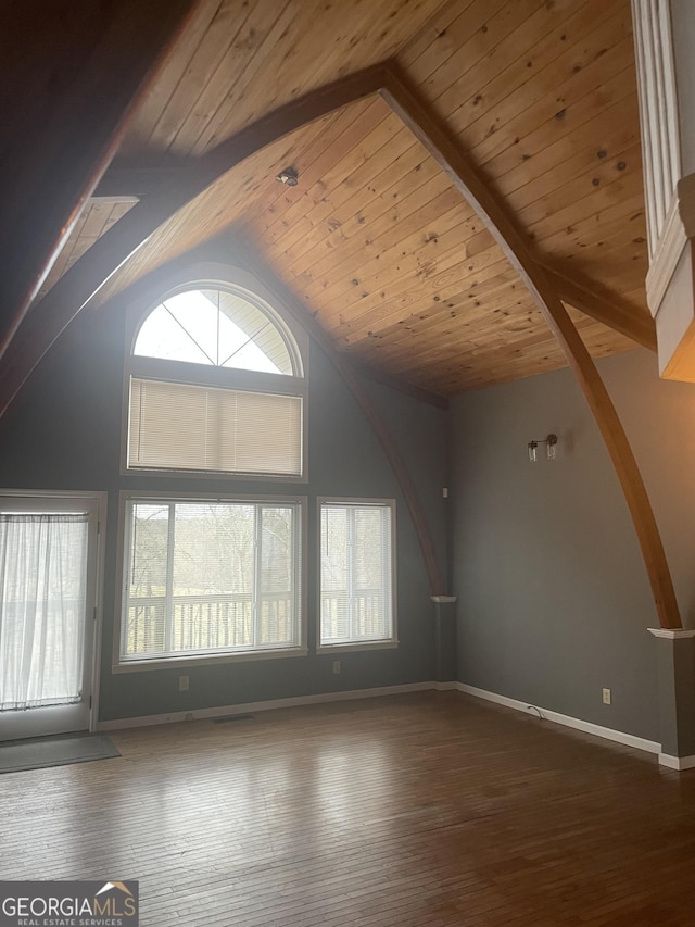 unfurnished living room with wooden ceiling, baseboards, high vaulted ceiling, and wood finished floors