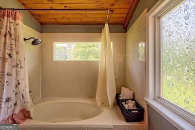 bathroom featuring wood ceiling and shower / bath combo with shower curtain