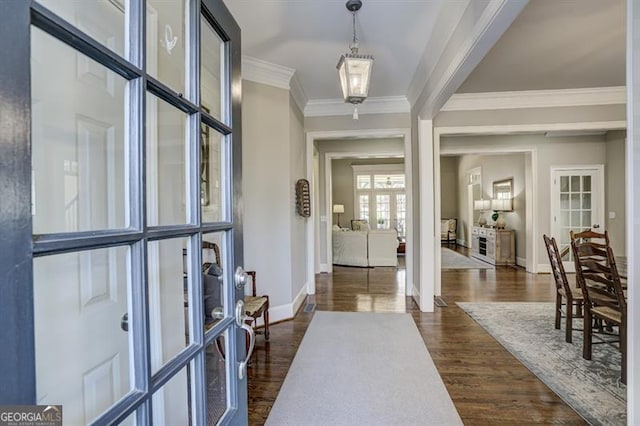 entrance foyer featuring french doors, ornamental molding, dark wood finished floors, and baseboards