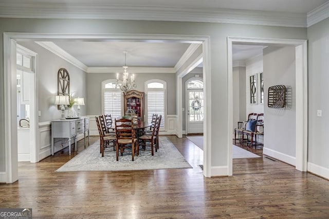 dining room featuring dark wood-style floors, a wealth of natural light, and a chandelier